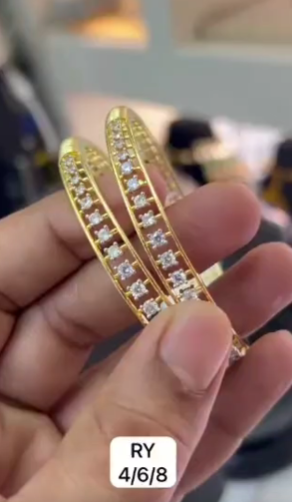 Pair of gold-plated bangles with CZ diamonds in a baguette design