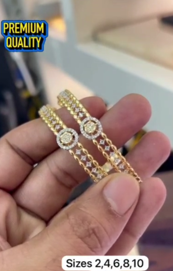 Gold-plated bangles feature an intricate filigree design