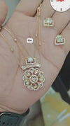Kundan pendant necklace set featuring a delicate chain and floral design