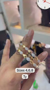 Gold-plated bangles with leaf-shaped designs