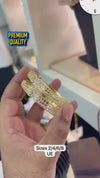 Gold-plated bangles feature intricate, machine-cut CNC designs