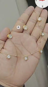 Gold-plated station necklace featuring multiple round, bezel-set simulated diamond